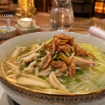 Soto ayam kampung kuah bening gurih dengan suwiran ayam, bihun, kol, dan bawang goreng dalam mangkuk hangat